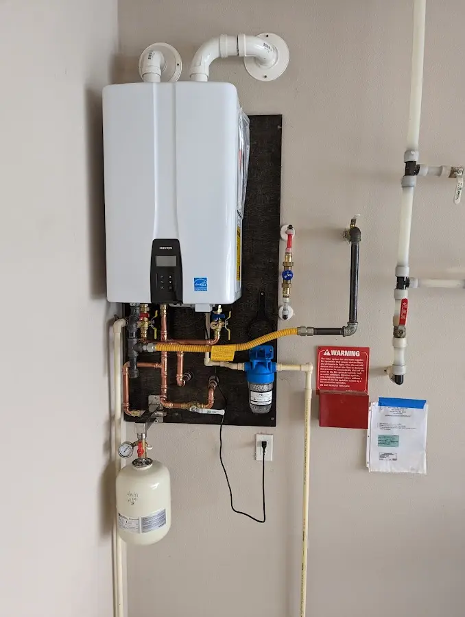 Professional plumber installing copper piping in a Pampa home